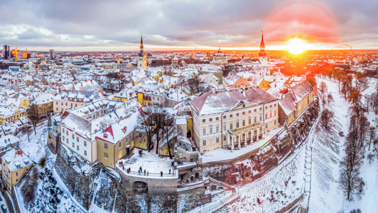 Tallinn in winter with a snow-covered Old Town at sunset