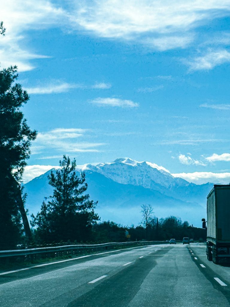 Road towards snow-covered mountains during our Peloponnese winter road trip