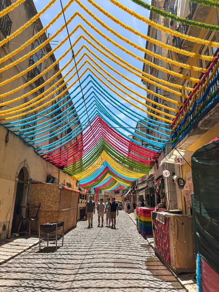 Colourful decorated street in Alfama, one of the most atmospheric areas to stay in Lisbon