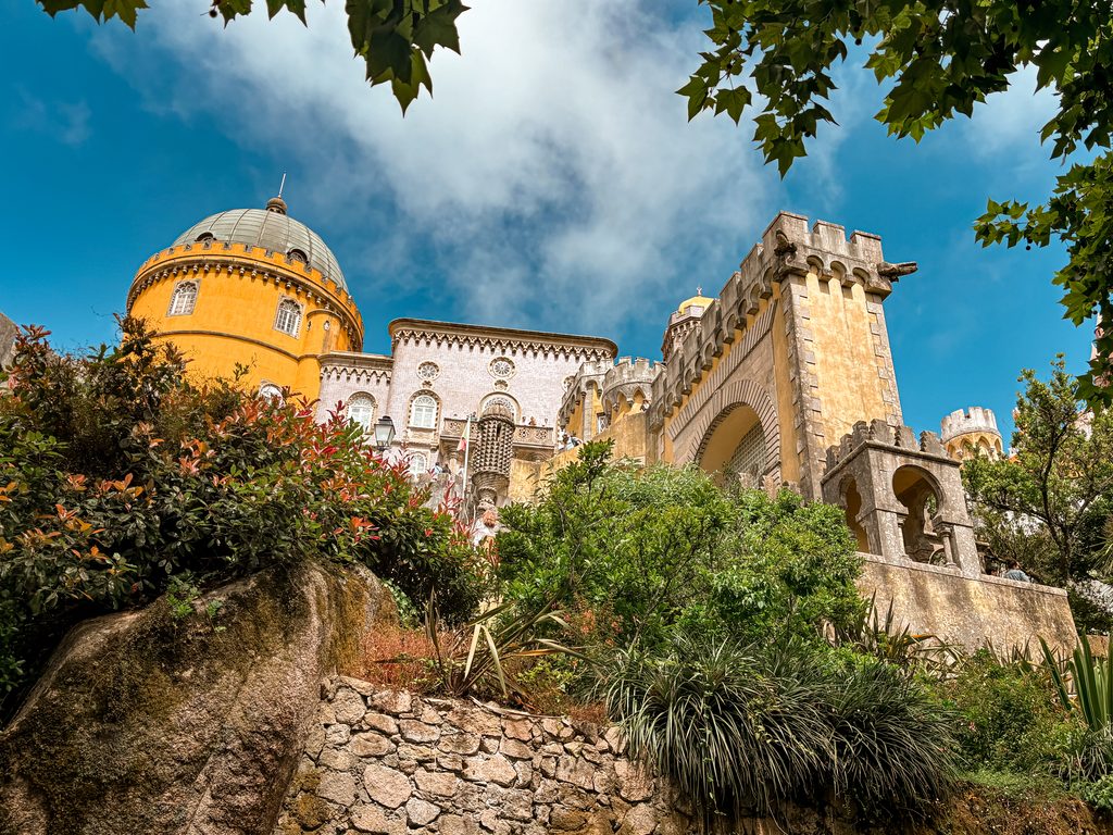 Pena Palace rising above its gardens in Sintra, one of the main stops on our Sintra day trip itinerary.