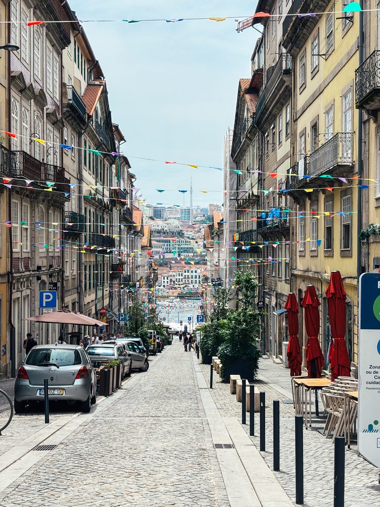 Colourful street in Porto's historic centre decorated with festival flags
