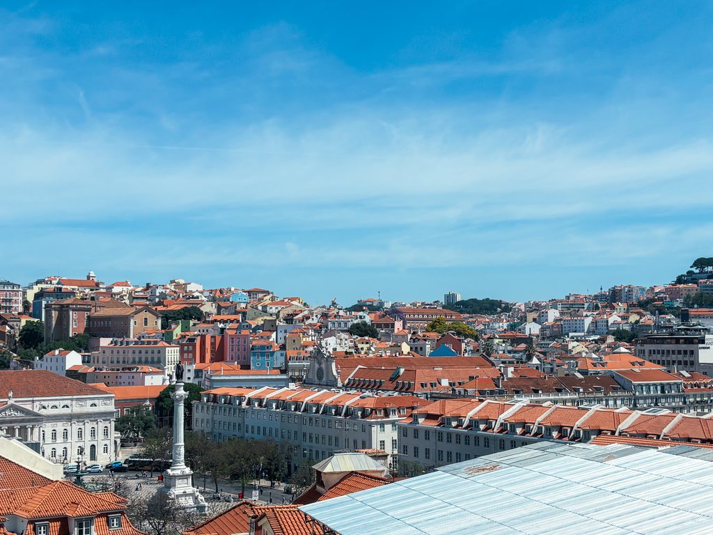View over Rossio Square and central Lisbon, one of the best areas to stay in Lisbon for first-time visitors. Best area to stay in Lisbon.