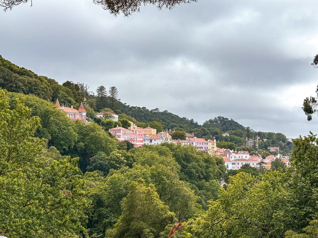 Colourful houses in Sintra’s historic centre spread across the wooded hillside beneath low clouds.